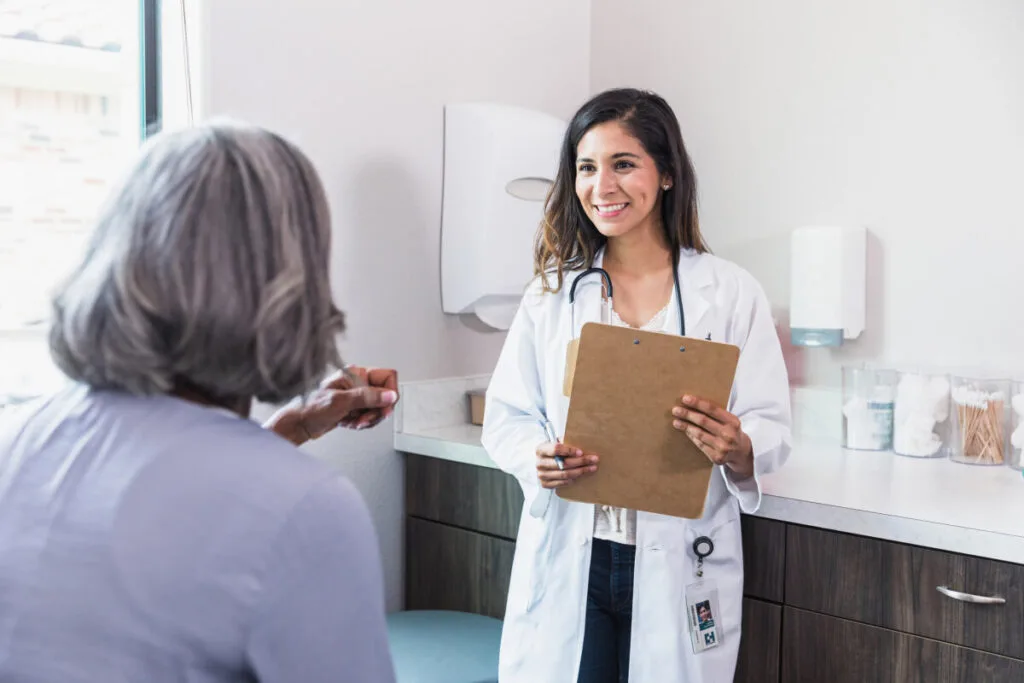 Senior woman talking with caring female doctor